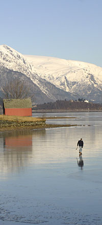 Lone ice-skater near Odda in Hardanger, with Folgefonna glacier beyond